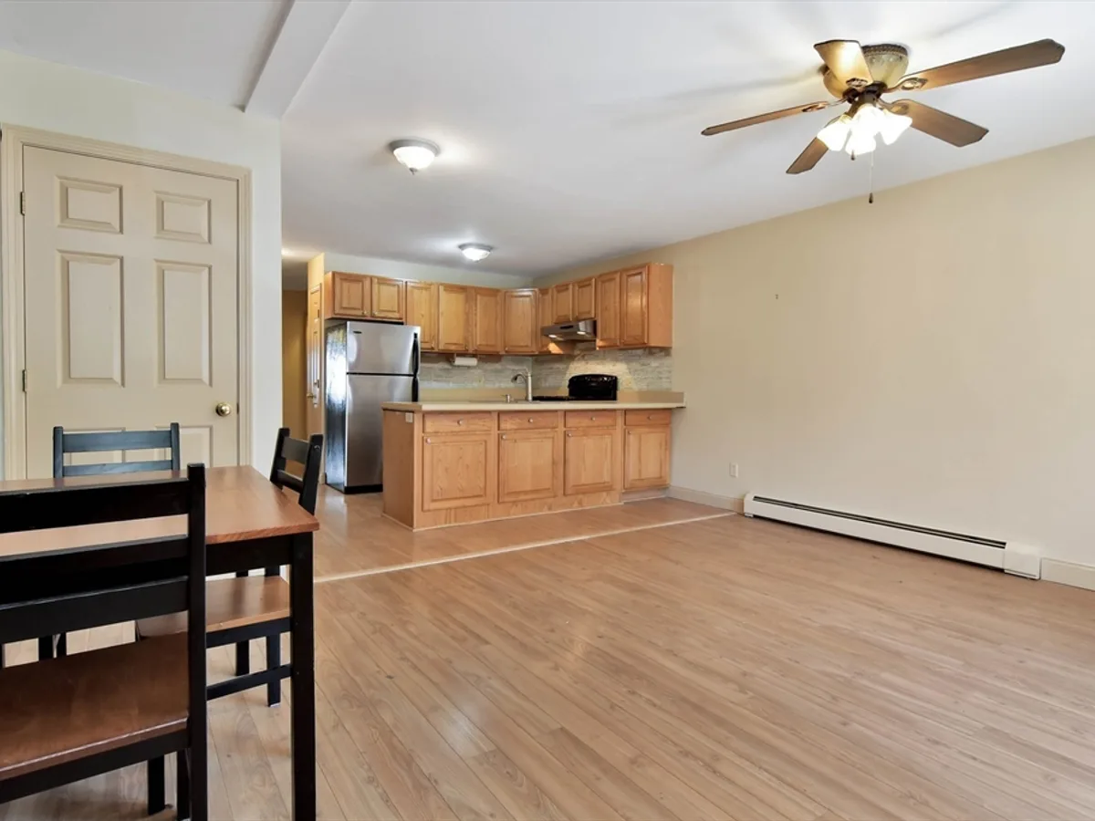 Compact open-plan living area with a small dining table and kitchen