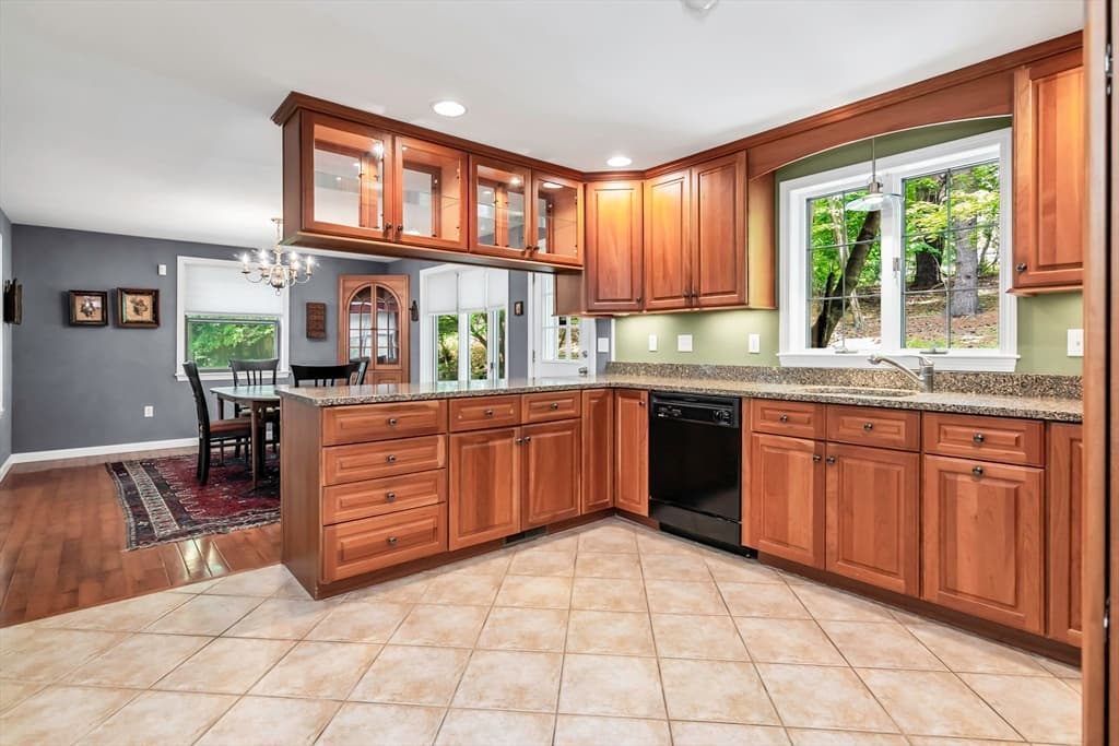Kitchen with wood cabinetry, tile floor, and natural light